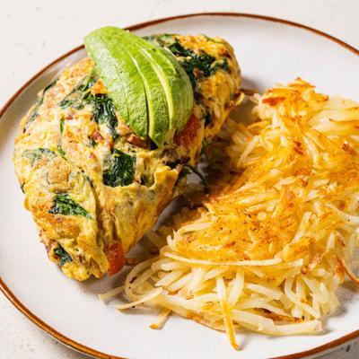 Omelet with avocado and hash browns.