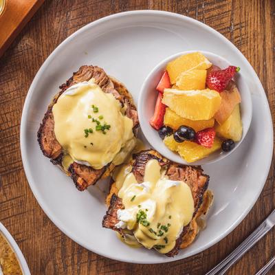 Brisket eggs Benedict with a fruit salad