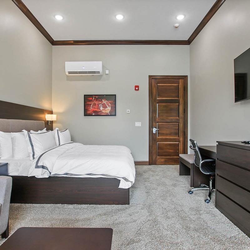 An interior of a bedroom, a large bed, furniture.