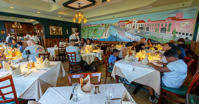 Nicely done interior dining area full of guests enjoying their food and drinks