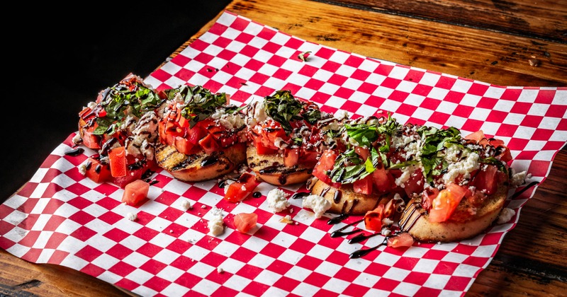 Bruschetta served on a red checkered paper