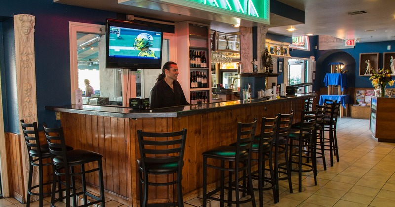 Interior, bar area, wooden top bar with stools, tile flooring