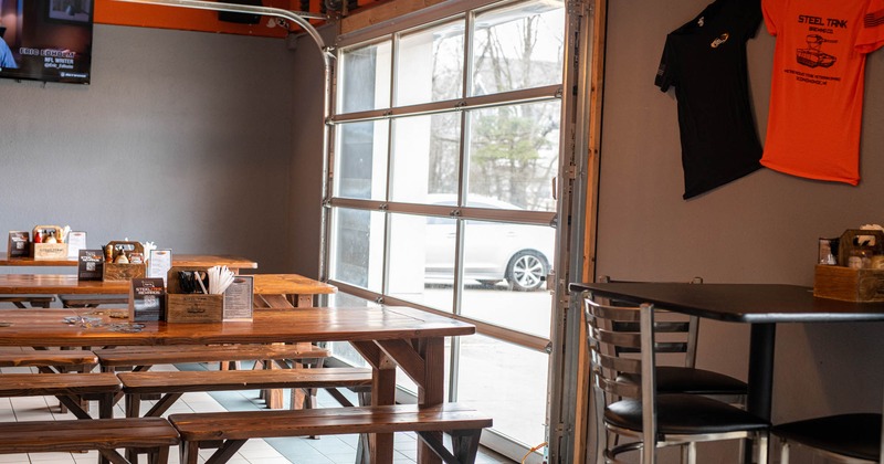 Interior, dining area, long tables and wooden benches, a table with chairs