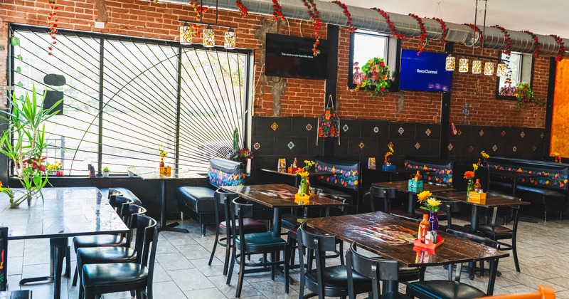 Interior, dining area, seating booths, wooden top tables for eight, six and four people