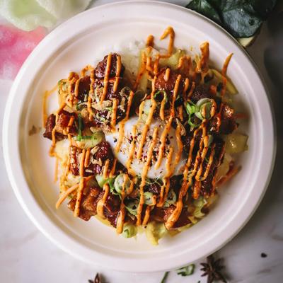 Pork in Filipino BBQ sauce on rice with veggies and egg.