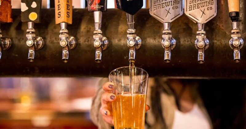 Bartender pouring beer from tap