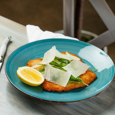 Pork Milanese Panko crusted pork loin, Topped with Jubilant Farms arugula and Parmigiano Reggiano.