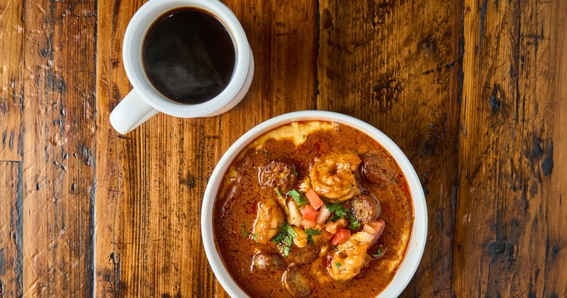 Shrimp and grits with a cup of coffee