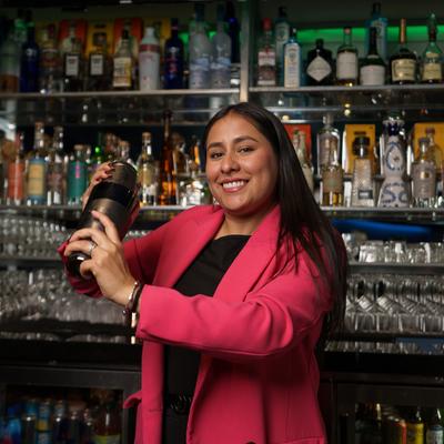 A staff member mixing a cocktail