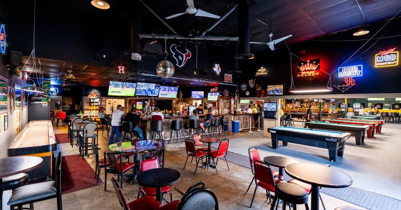 Spacious sports bar interior space, seating area, bar, and pool tables