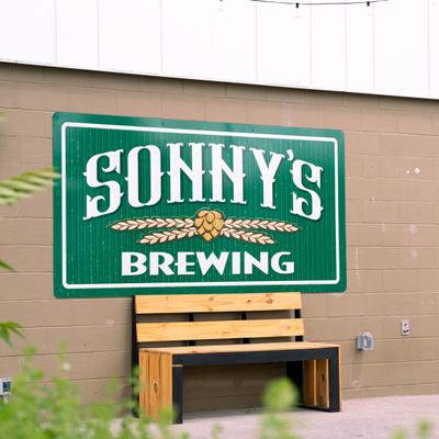 Brewery sign above a bench.