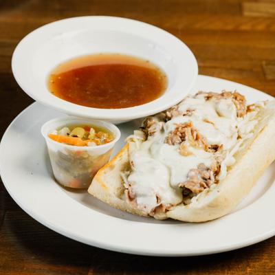 Italian beef sandwich with melted mozzarella cheese, served with pickled veggies and au jus.