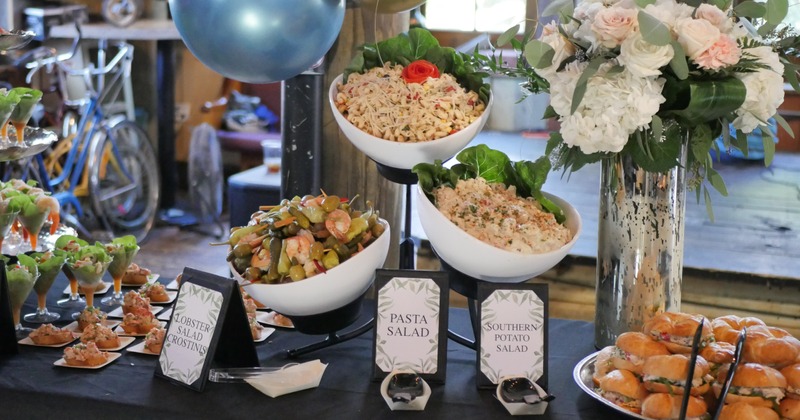 A table decorated with flowers, with appetizers and salads