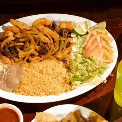 Steak fajitas served with rice, beans and a salad.