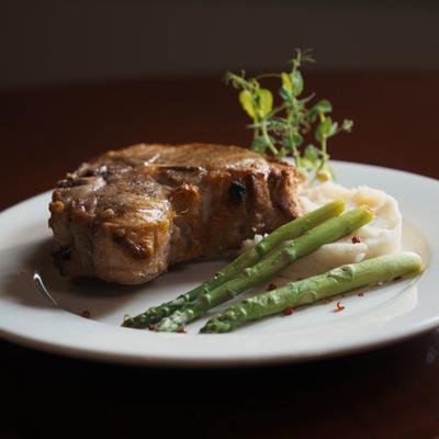 Veal chop with mashed potatoes and asparagus.