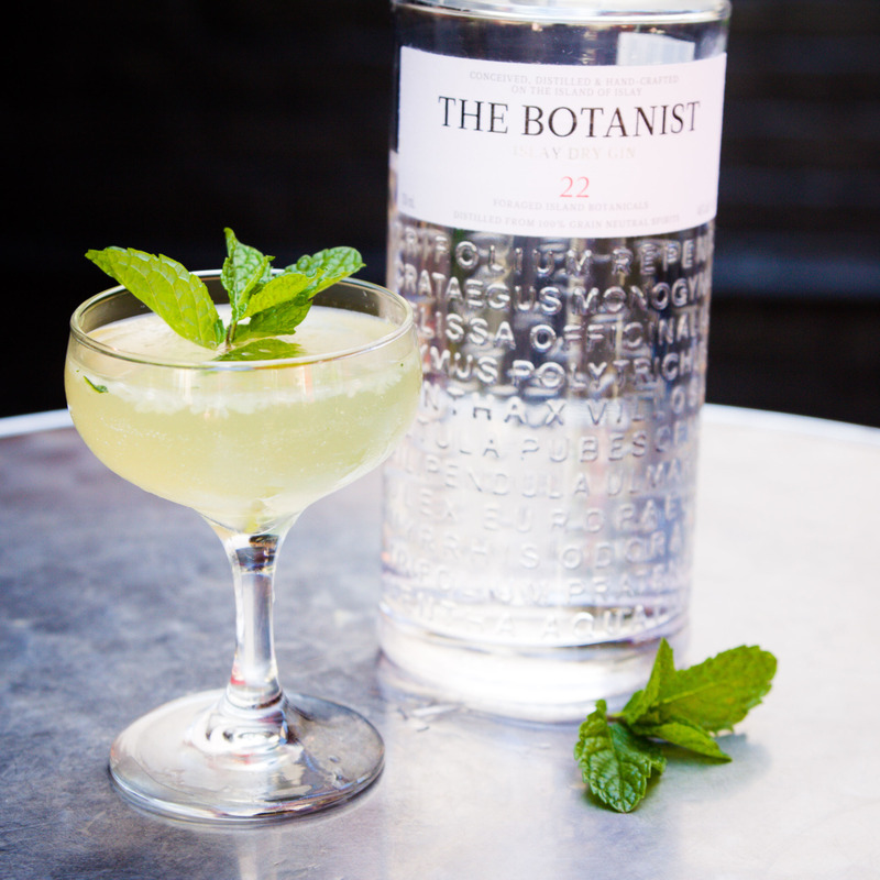 Translucent mojito and a bottle of The Botanist