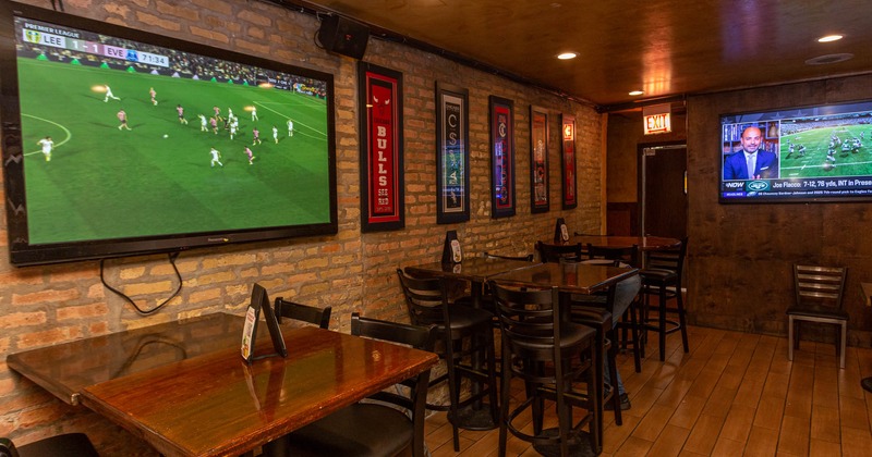 Interior, seating area with large TVs on walls