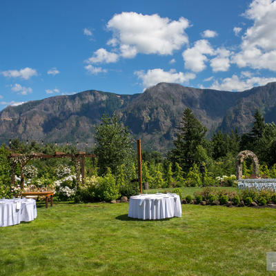 Restaurant grass area with tables and natural landscape in the back
