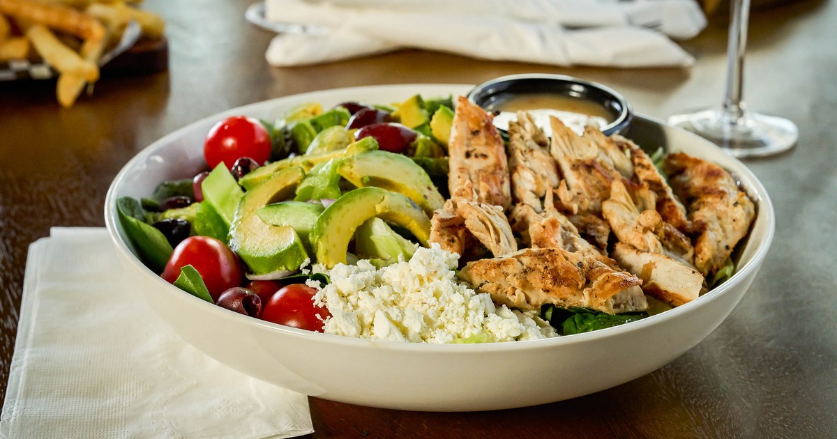 Chicken salad with avocado, tomatoes, and cheese