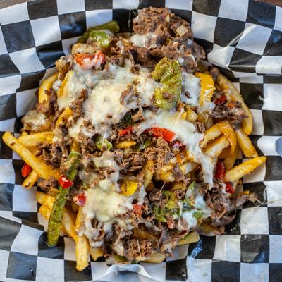 Loaded Fries, with bacon, cheese, and greens.