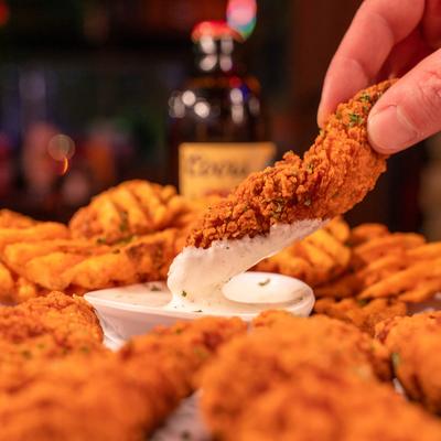 A hand holding fried food