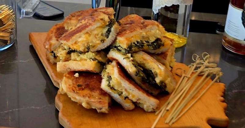 Grilled sandwiches served on a wooden board