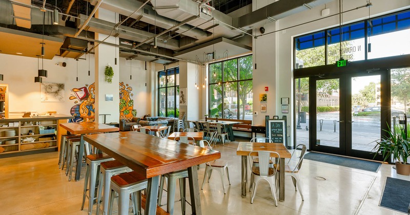 Interior dining area, two tall tables and bar stools