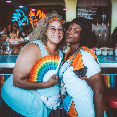 A photo portrait of two smiling guests