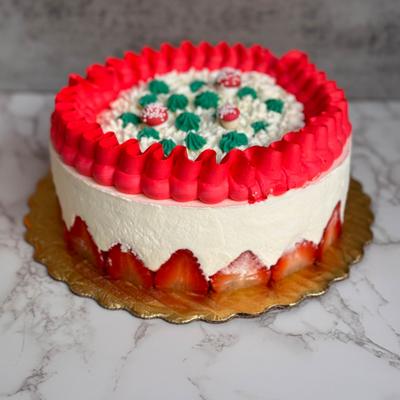 Whole strawberry cake served on the table.