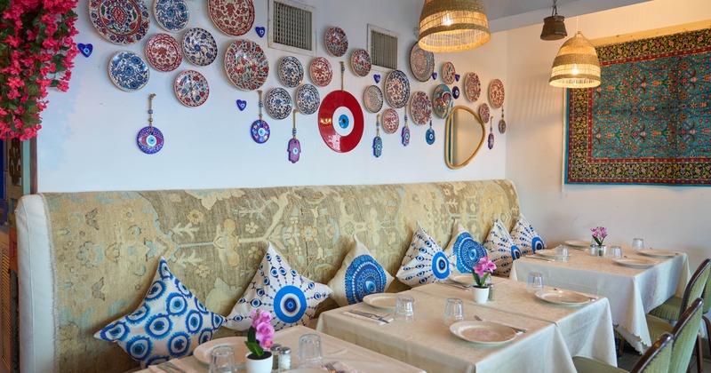 Interior, tables, chairs and sofa with pillows