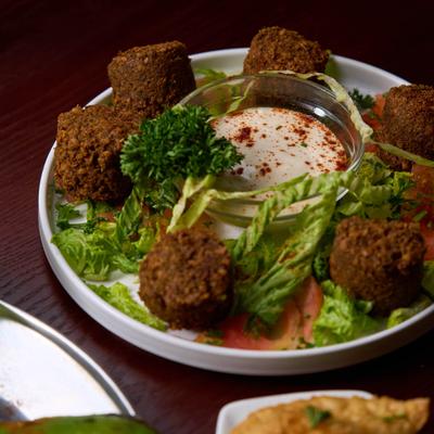Falafel with veggies and dipping sauce.