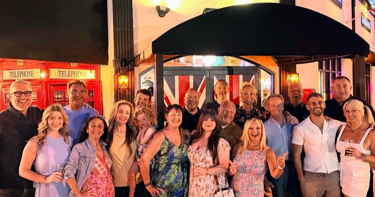 Group of people posing outside pub