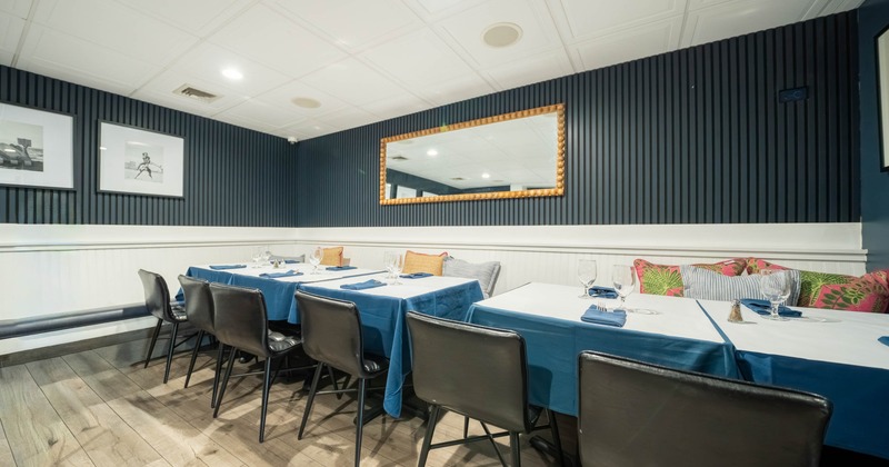 Interior, dining area, wooden banquette bench with tables and chairs, ready for guests