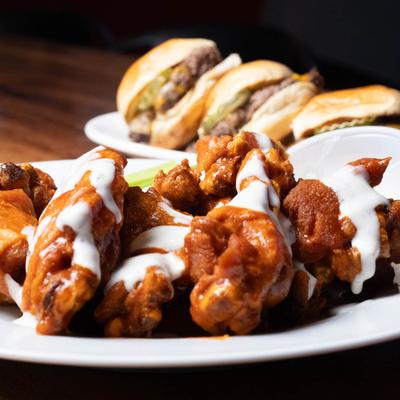 Chicken wings topped with dressing.