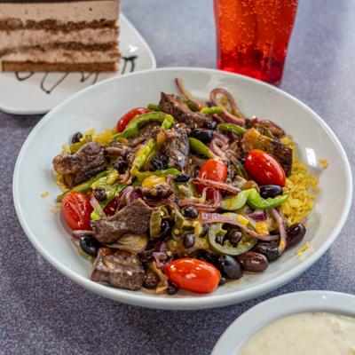 Bowl of marinated steak fajitas with rice.