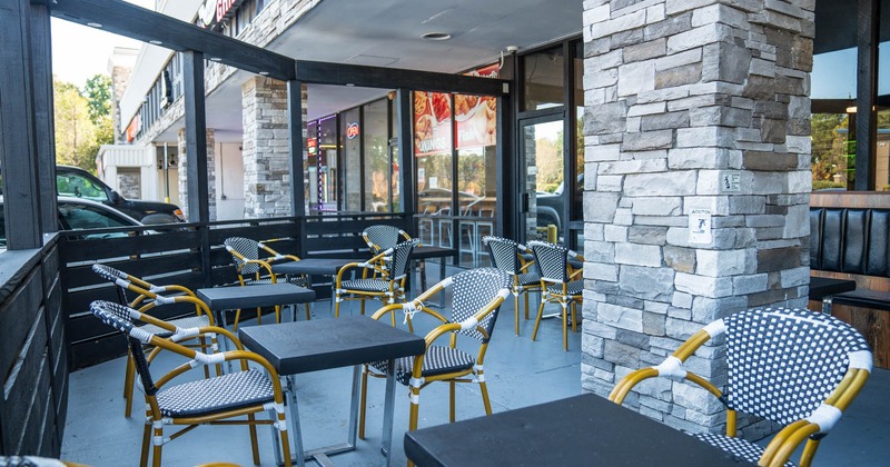 Exterior, patio, partially covered seating area, tables for four and two