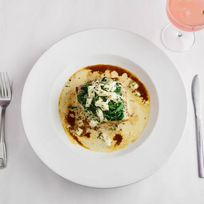 Lasagna plate paired with a refreshing pink cocktail.