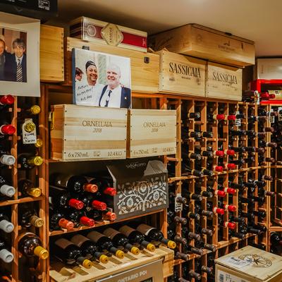 Numerous bottles and crates on shelves.