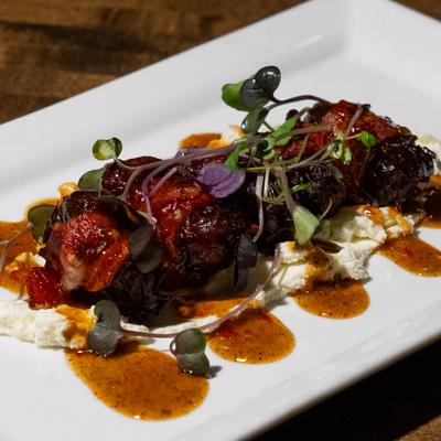 Bacon Wrapped Dates with goat cheese mousse and sweet chili jalapeno jam.