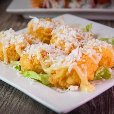 Coconut shrimp on a bed of lettuce, topped with shredded coconut.