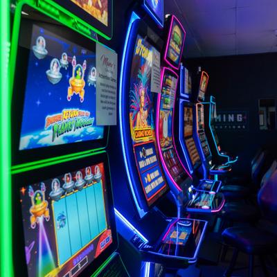 Row of slot machines with glowing lights.