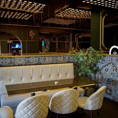 Interior, booth with table and padded chairs around