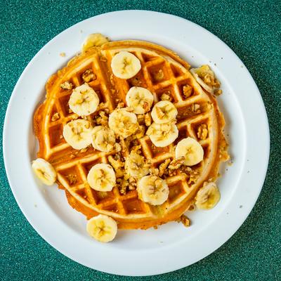 Banana and nuts on a waffle.