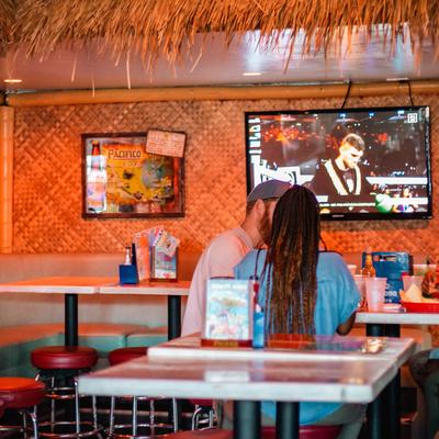 Couple dining and watching sports on TV