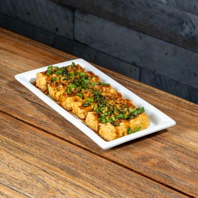 Fried tofu topped with herbs and seasoning.