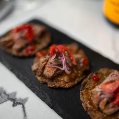Suya Tacos with plantain tortilla, mango chutney and herb pico.