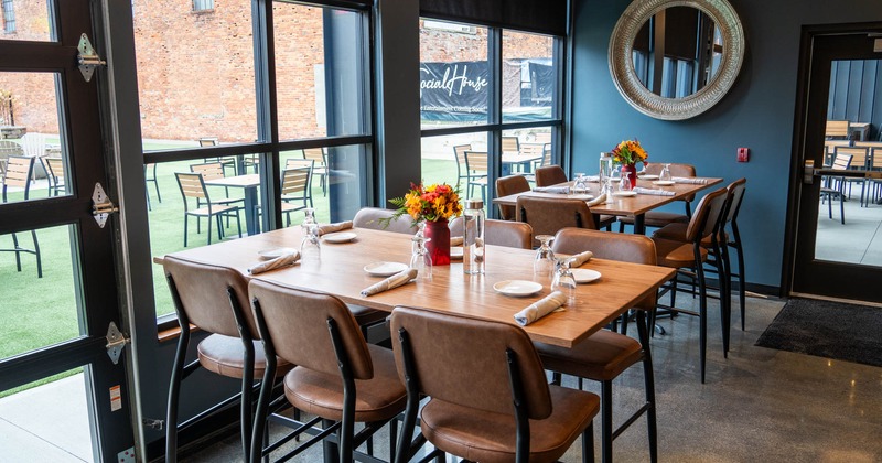 Two tables placed next to the windows