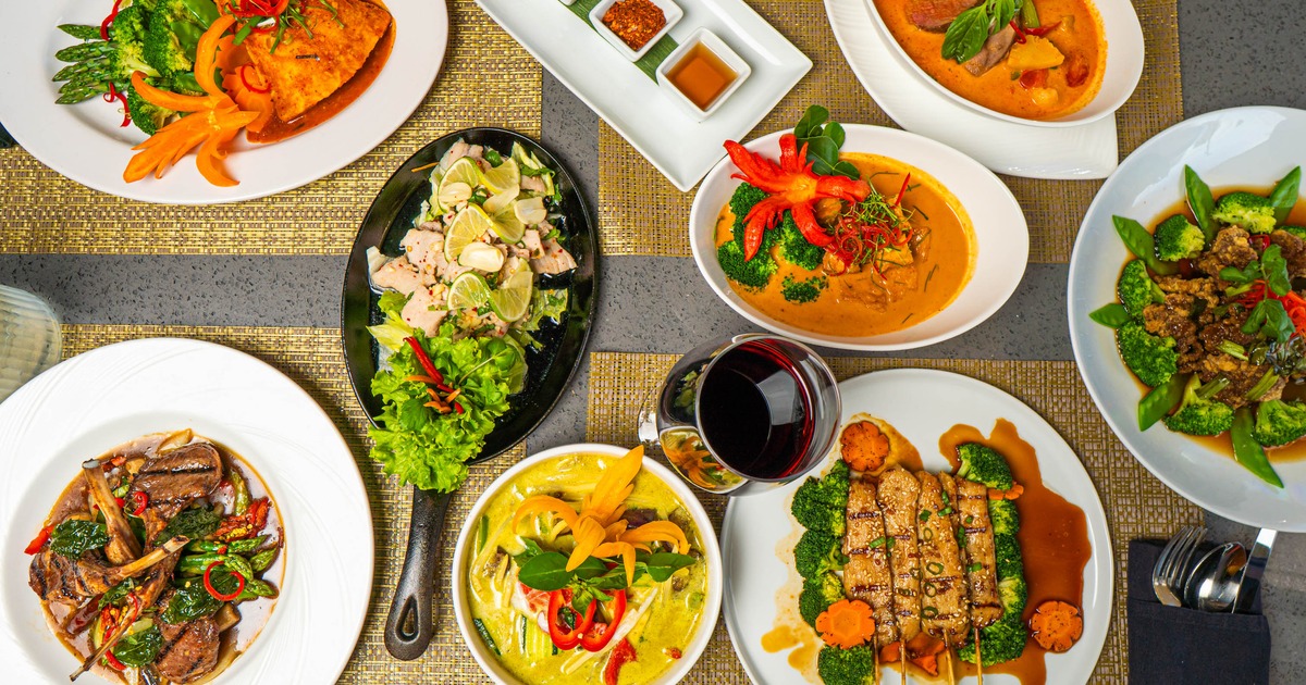 Assortment of dishes served on a table alongside a glass of wine
