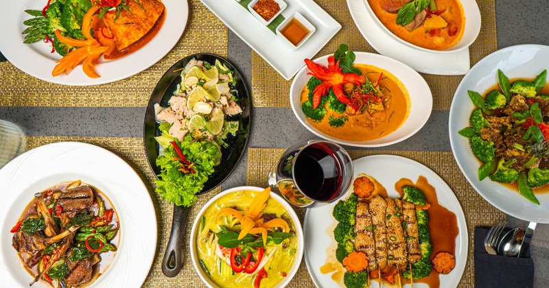 Assortment of dishes served on a table alongside a glass of wine