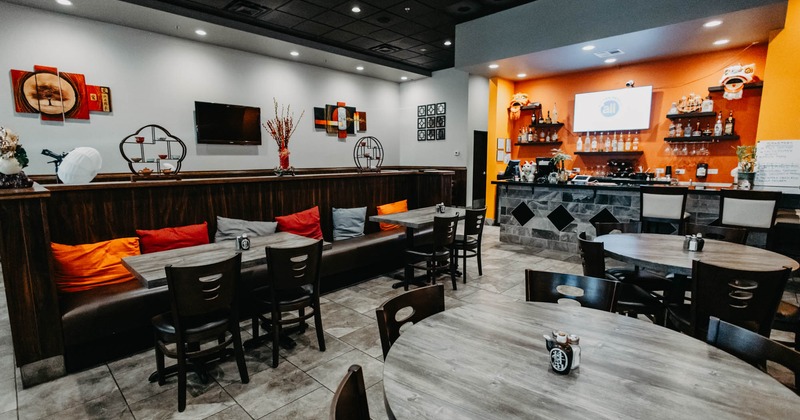 Interior, dining area, round tables for six, banquette bench with tables and chairs